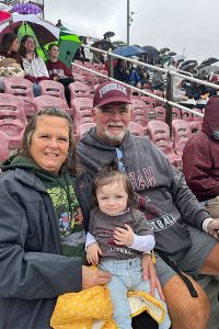 Brian Kelly, GABELLI ’84, with his wife and granddaughter.