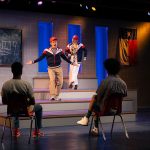 students perform on stage in High School Play