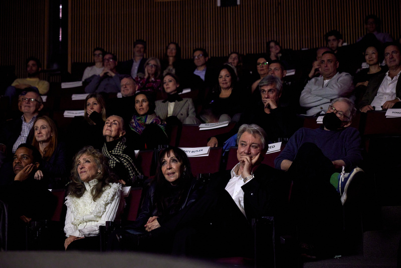 Bonnie Timmerman and others watch the film from their seats.