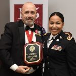 Stephanie Ramos holds her plaque with a fellow member of the military.