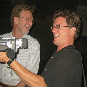 Ross McLaren holding a video camera, while standing beside Joseph Lawton