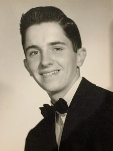 A black and white photo of Leo Daly as a young man
