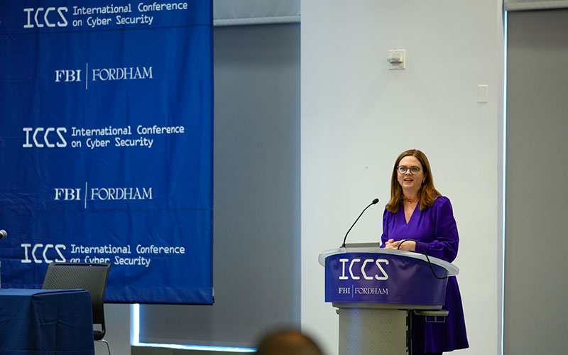 President Tania Tetlow speaks at a podium at ICCS.