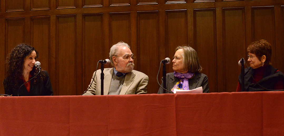 Orlando and Phyllis Rodriguz sitting at a table with two panelists at a Fordham event