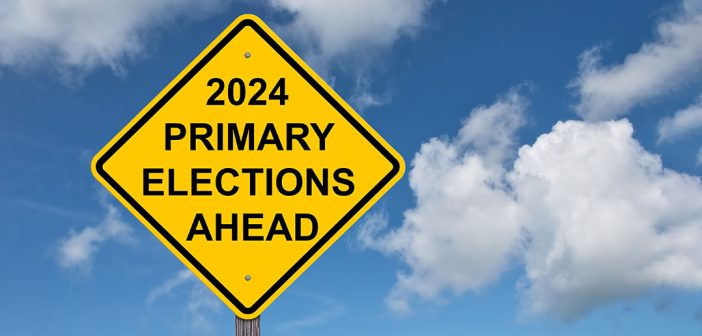 Yellow sign that reads 2024 primary elections ahead, against a blue sky
