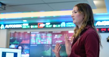 A student presents in the trading room