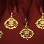 A group of medals on a maroon tablecloth