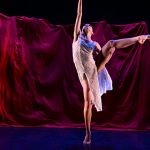 A Fordham Ailey student dancer performs on stage.