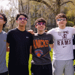 Row of young men with eclipse glasses